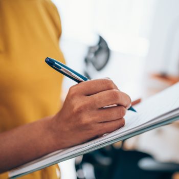 Cropped shot of an unrecognizable businesswoman making notes on a clipboard inside of the office.